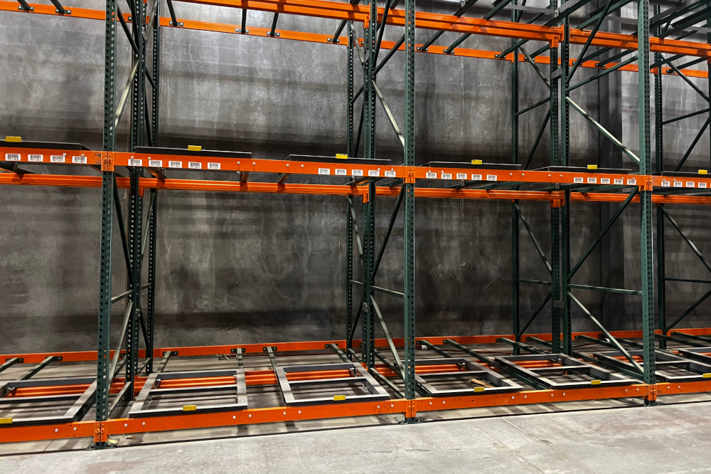 Forklift loading a pushback rack lane